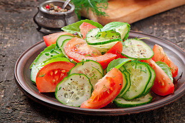 Tomato and cucumber salad with black pepper and basil