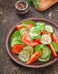 Tomato and cucumber salad with black pepper and basil