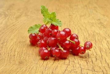 Red currant on wooden background