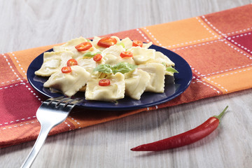 Portion of ravioli with red pepper