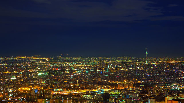 Illuminated Skyline of Tehran Against Dark Blue Sky