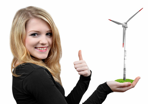 Girl holding in hand wind turbine