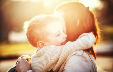 Mother hugging her child in the park