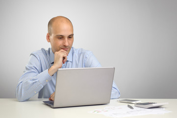 Fototapeta na wymiar Handsome businessman working with laptop in office