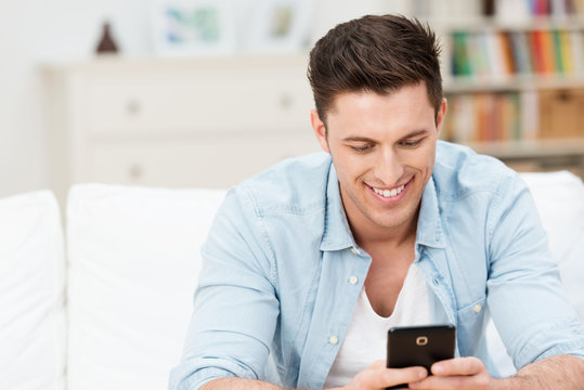 glücklicher junger mann mit smartphone