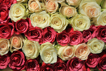 Pink roses in different shades in wedding arrangement