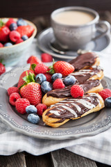 Chocolate eclairs with fresh berries