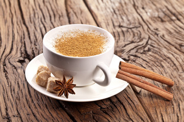 Cup of cappuccino decorated with spices.