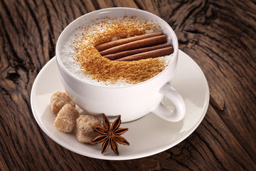 Cup of cappuccino decorated with spices.