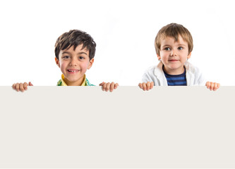 Kids holding empty placard over white background