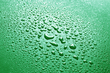 Water drops on green background