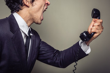 Naklejka premium Angry businessman on the phone