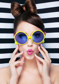 Attractive surprised young woman wearing sunglasses