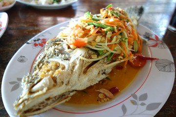 Green papaya salad on Fried snapper