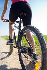 Naklejka premium Fit woman riding mountain bike