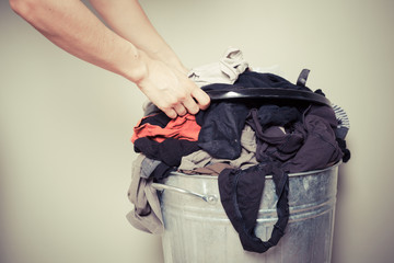 Woman sorting out her laundry - obrazy, fototapety, plakaty