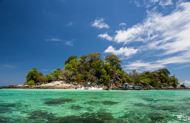 tropical island with clear water and blue sky