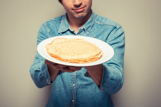 Man with stack of pancakes