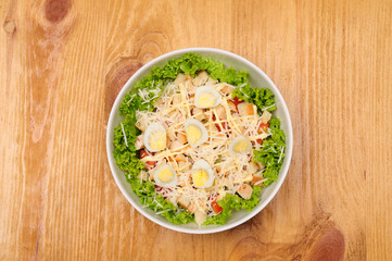 Fresh salad with chicken breast, cheese and eggs