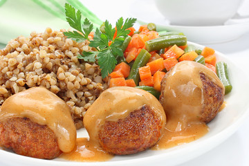 Pork meatballs with sauce, buckwheat, green beans and carrots