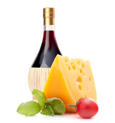 Red wine bottle, cheese and tomato still life