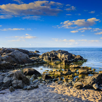 sea coast with boulders and sand