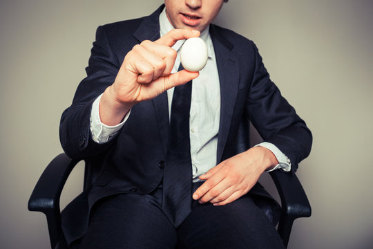 Businessman holding an egg