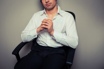Casual young businessman in office chair