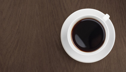 Fototapeta na wymiar black coffee on wooden table top view