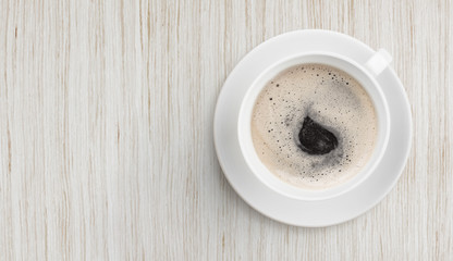 black coffee on white wooden table top view