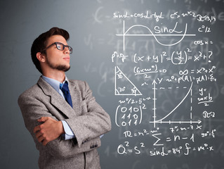 Handsome school boy thinking about complex mathematical signs