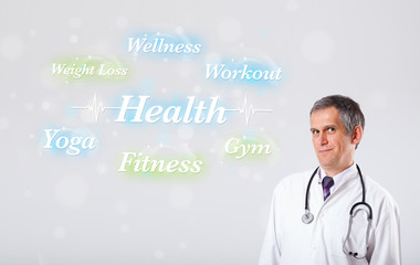 Clinical doctor pointing to health and fitness collection of wor
