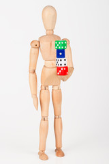 Wood mannequin holding colourful block dice isolated on white