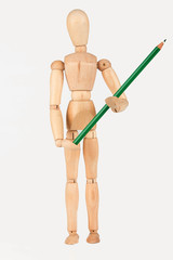 Small wood mannequin standing with colour pencil isolated on whi