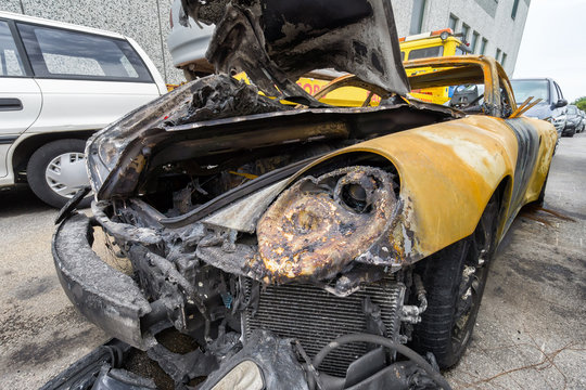 yellow sport car crashed and burned