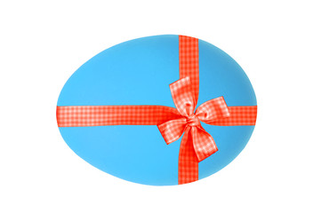 Blue Easter egg with red ribbon and bow isolated on white