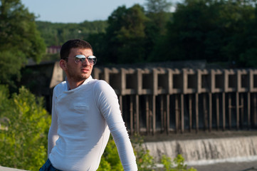 The young man smiles close up