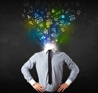 Business man with glowing media icons exploding head