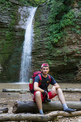 The young man smiles close up