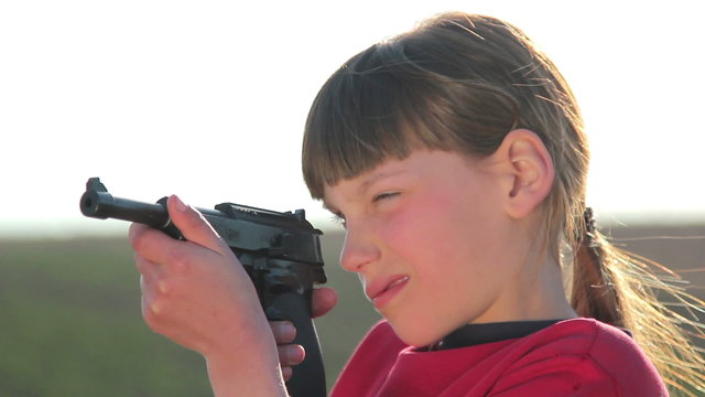 Boy with gun.Boy playing weapon.Teenager a gun aiming.