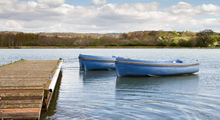 Small boats tied to a wooden jetty