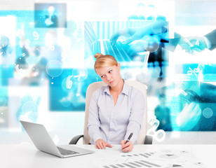 Business person at desk with modern tech images at background