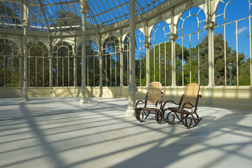 Fototapeta premium Two rocking chairs in the Crystal Palace in Madrid