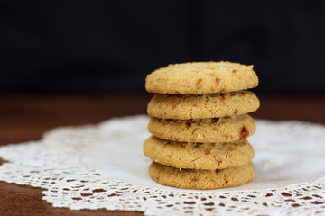 Fototapeta na wymiar Stacked apple chip cookies on white rustic napkin - 1