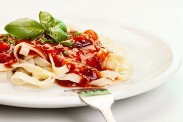 Pasta fettuccine with tomato sauce and basil