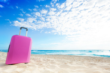 Pink baggage on the sand
