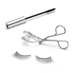 fake false eyelash with eyelash curler and mascara on white
