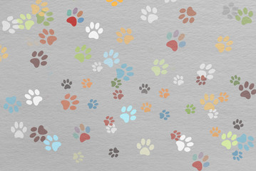 Fototapeta na wymiar traces colored paws on paper texture, children funny background