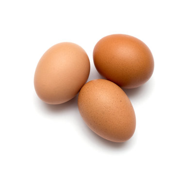 Three brown eggs isolated on white background