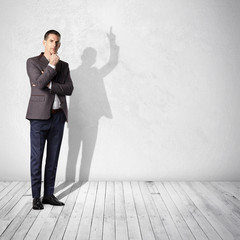 thoughtful businessman and his shadow showing up